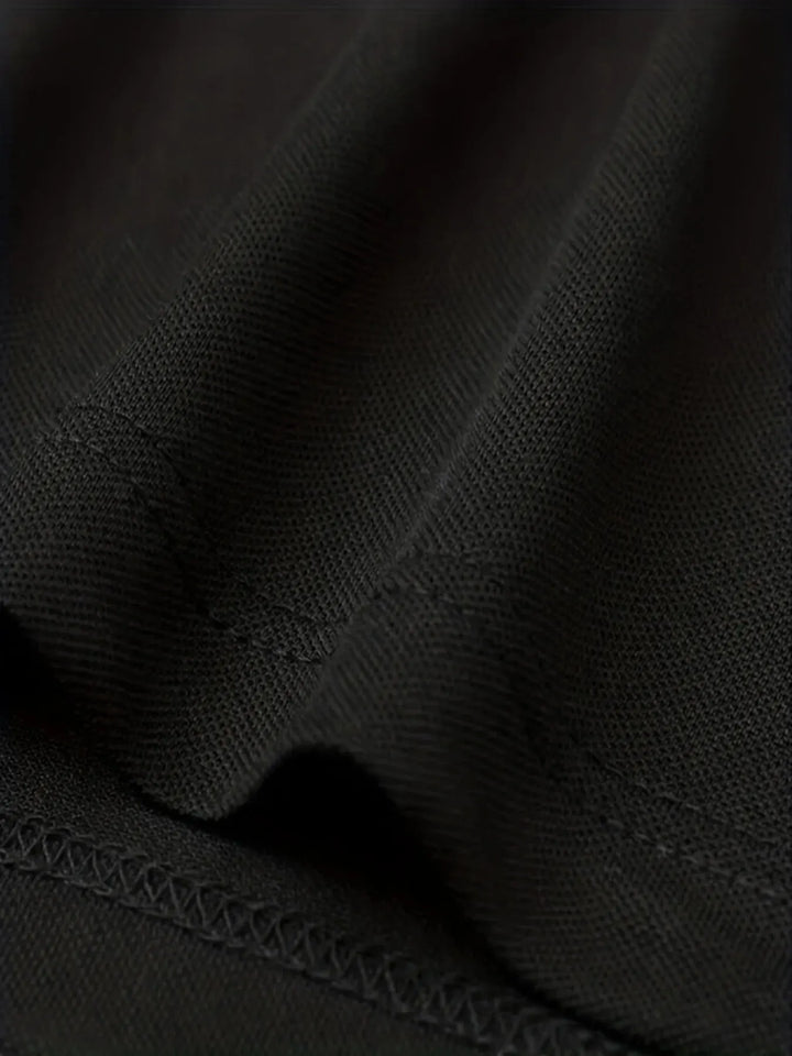 Close-up of breathable polyester fabric in black, showcasing texture for the SmartGearPros breathable polyester polo shirt.