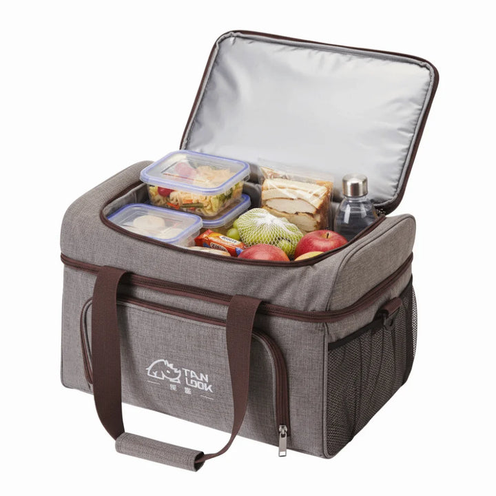 Gray insulated lunch bag with food items on a white background
