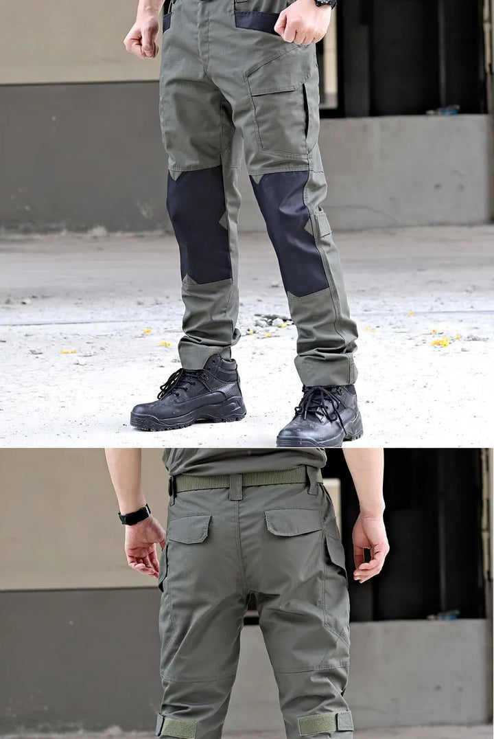 Gray cargo pants with black boots on a concrete surface.
