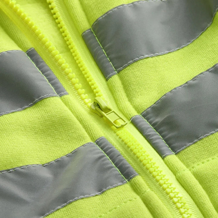 Close-up of a high-visibility safety vest with reflective stripes.