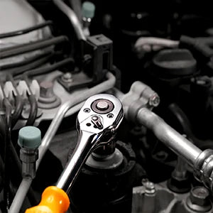 Close-up of a wrench and screwdriver on a mechanical engine background