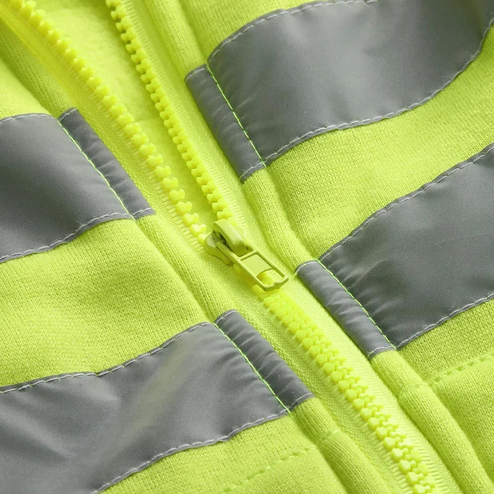 Close-up of a high-visibility safety vest with reflective stripes.