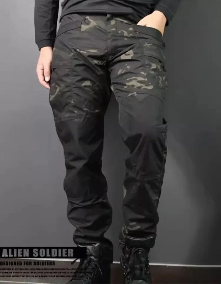 Person wearing black camouflage pants on a gray background with 'Alien Soldier' branding.