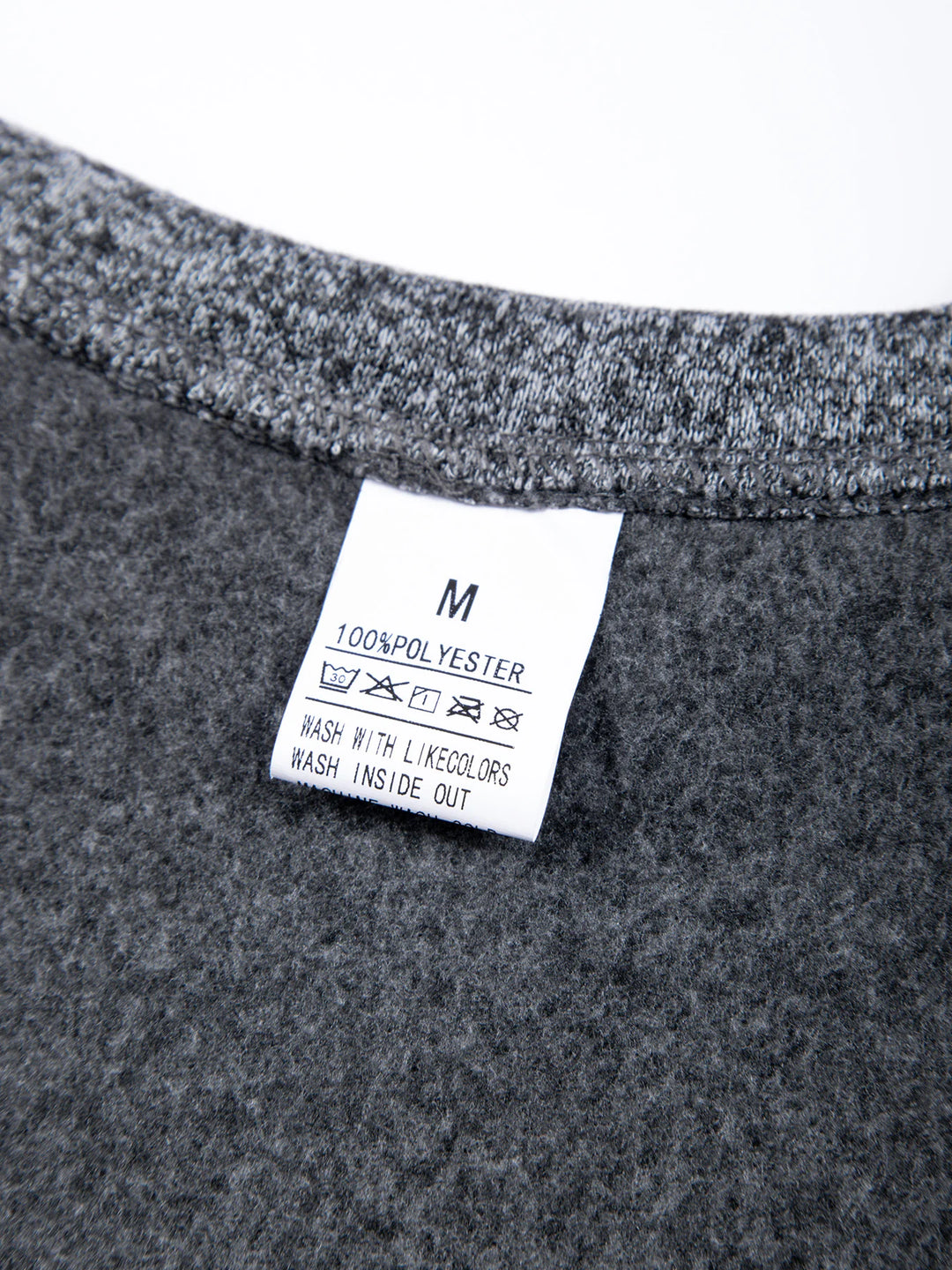 Close-up of a gray fabric with a label on a white background