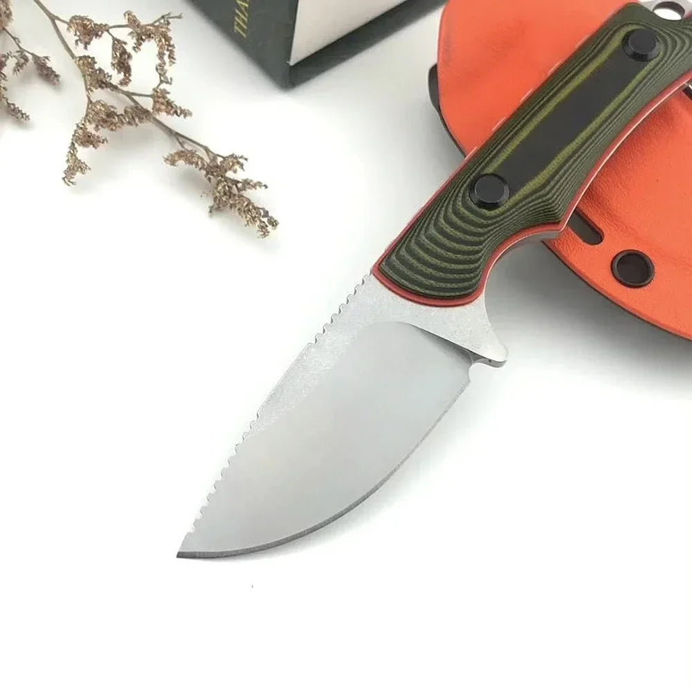 Folding knife with a green handle and orange sheath on a white background