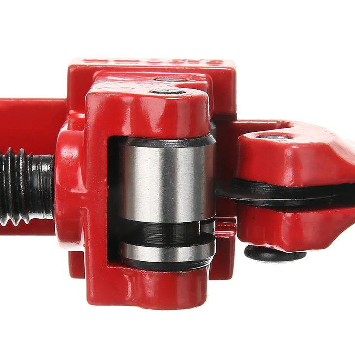 Red mechanical component of a pipe cutter with a metallic shaft on a white background