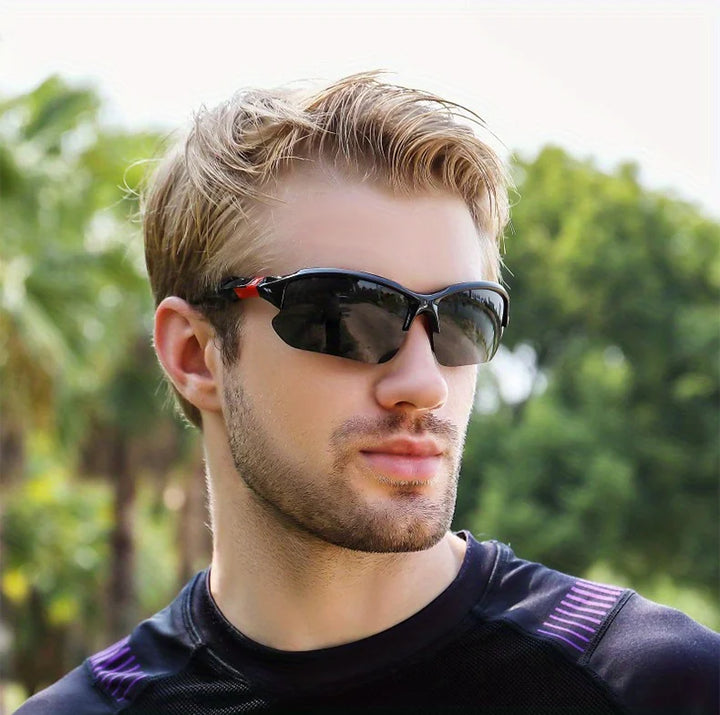 Man wearing sunglasses with a blurred green outdoor background