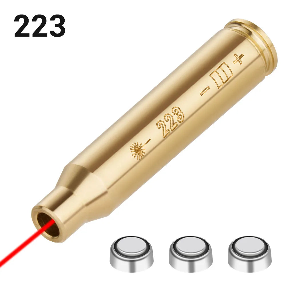 Gold laser bore sighter with '223' marking and red laser beam on a white background