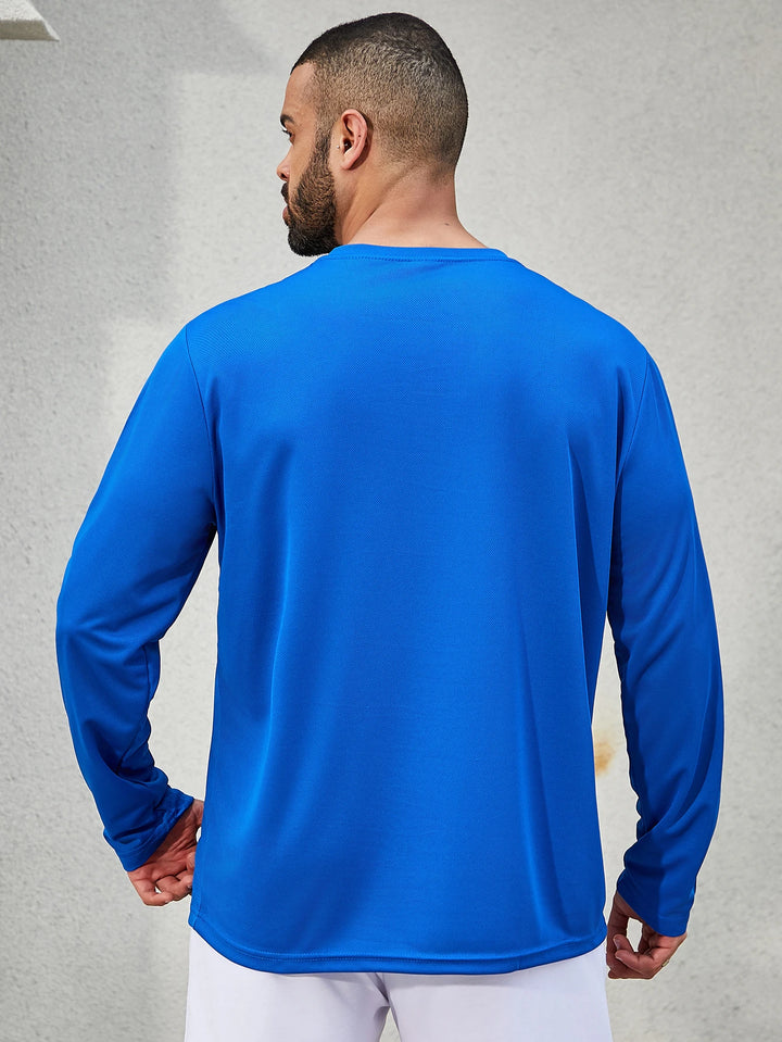 Man wearing a blue long-sleeve shirt against a gray background