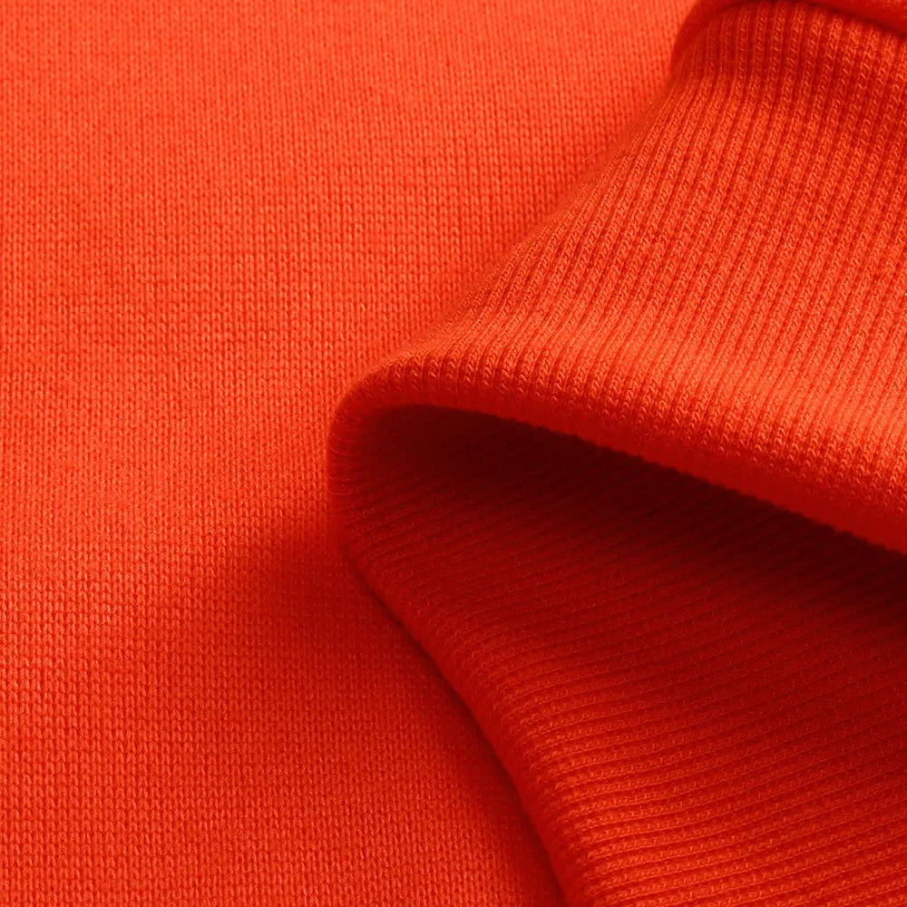 Close-up of orange fabric with a textured pattern