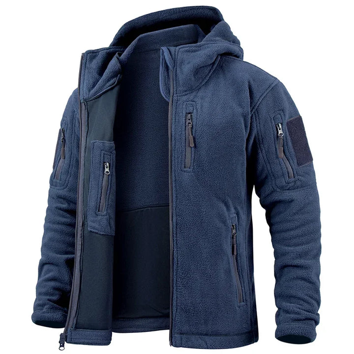 Dark green tactical jacket with multiple pockets and zippers on a white background