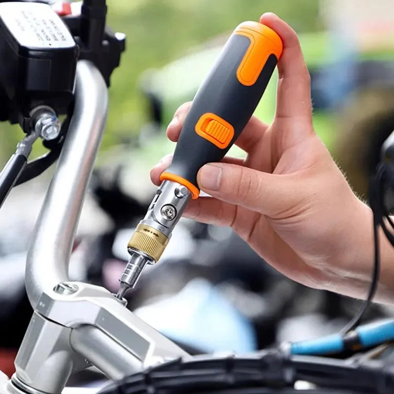 A user demonstrating the screwdriver in action, tightening a screw on a motorcycle.