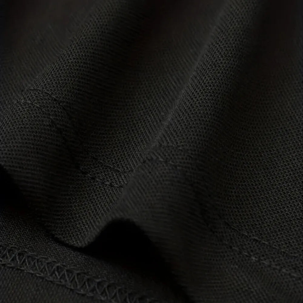 Close-up of the fabric texture of SmartGearPros breathable polyester polo shirt in black color.