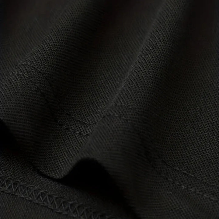 Close-up of the fabric texture of SmartGearPros breathable polyester polo shirt in black color.