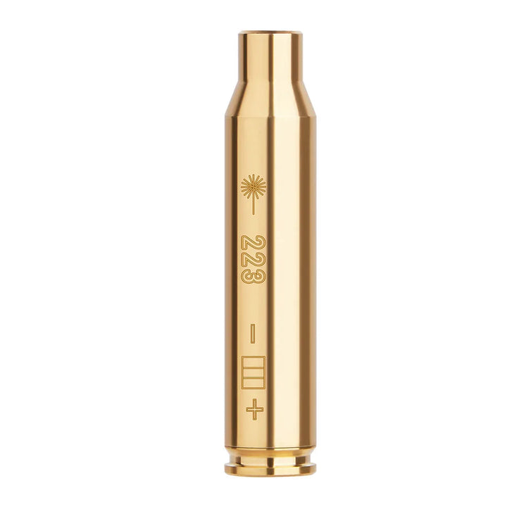 Gold-colored laser bore sighter on a white background