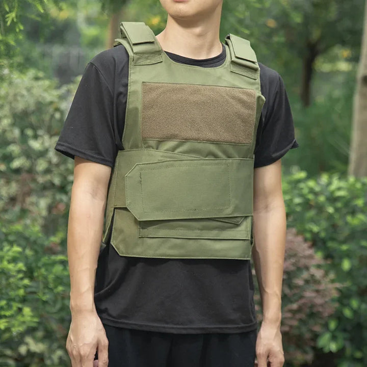 Person wearing a green tactical vest against a blurred natural background