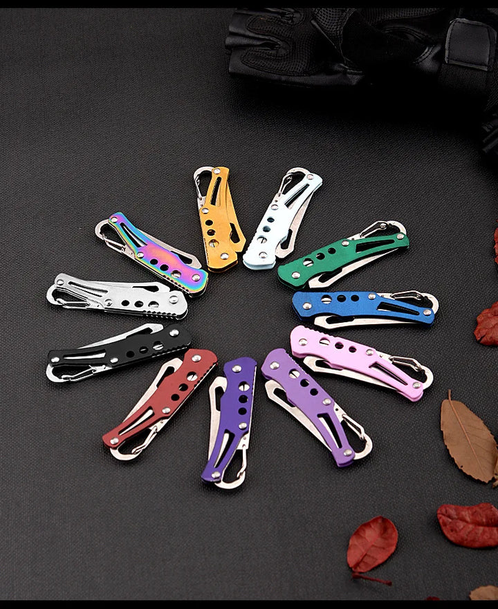 Colorful hair clips arranged in a circular pattern on a dark surface with leaves.