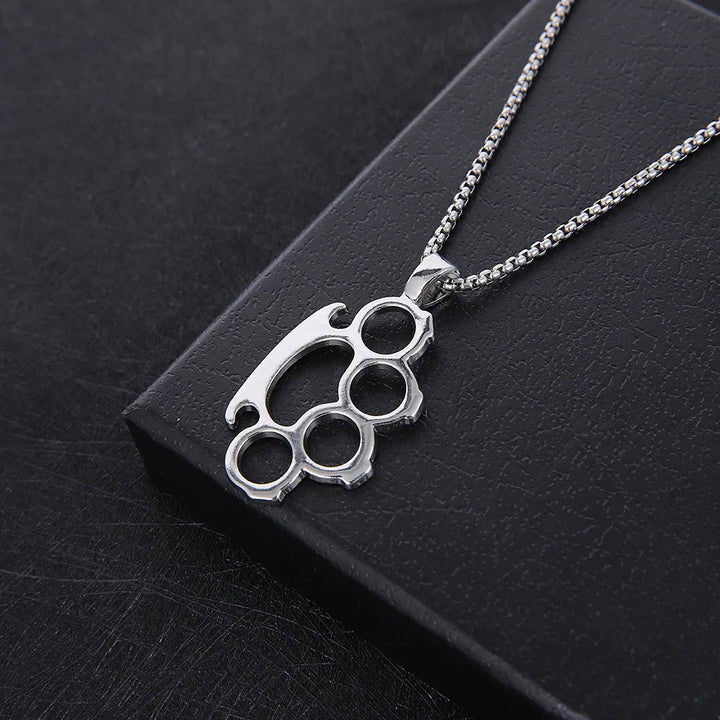 Silver knuckle duster necklace on a black background