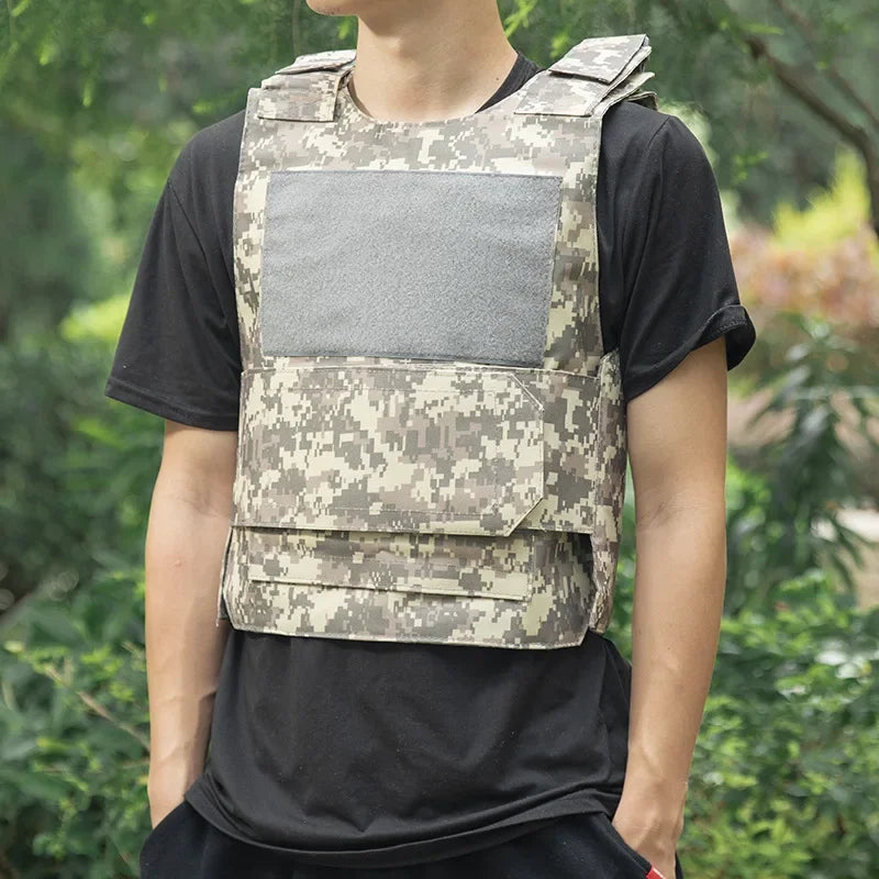 Person wearing a camouflage tactical vest with a black shirt against a green background