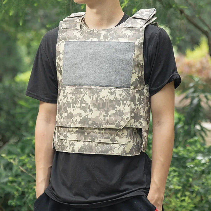 Person wearing a camouflage tactical vest with a black shirt against a green background