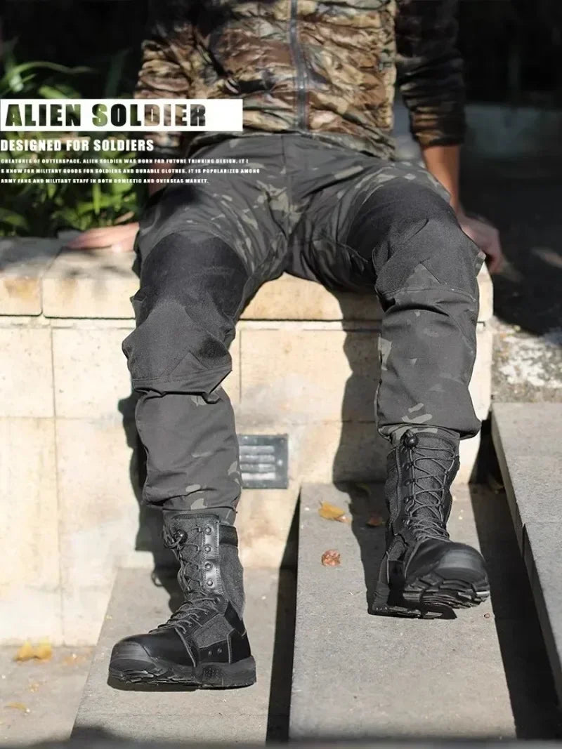 Person wearing black tactical boots and camouflage pants on a stone surface.