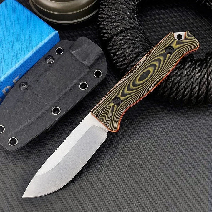 Folding knife with a decorative handle on a textured surface
