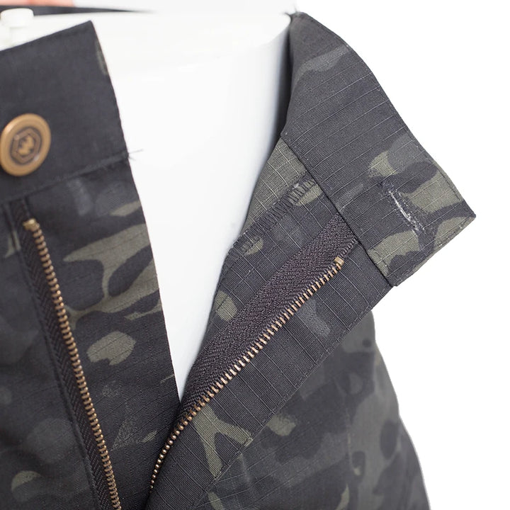 Camouflage-patterned jacket with zipper details on a white background