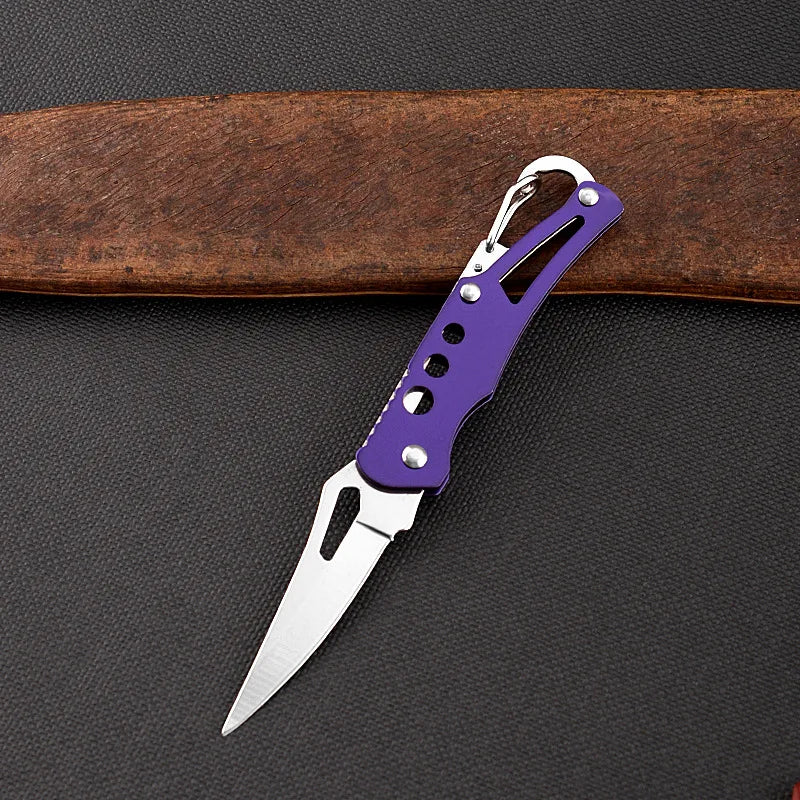 Purple folding knife on a dark surface with a brown belt in the background