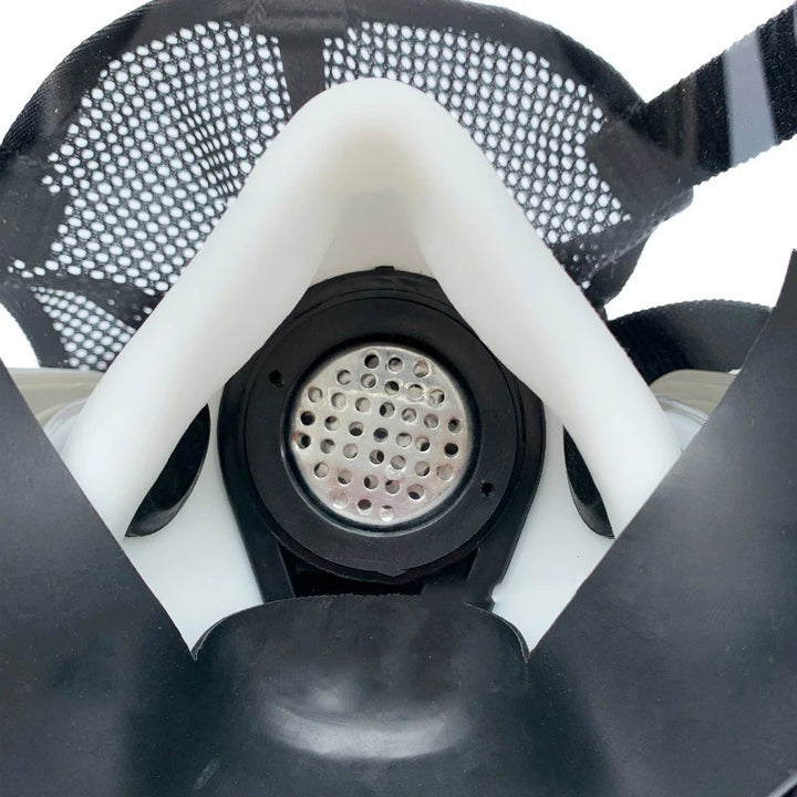 Close-up of a gas mask filter with a white frame and black mesh