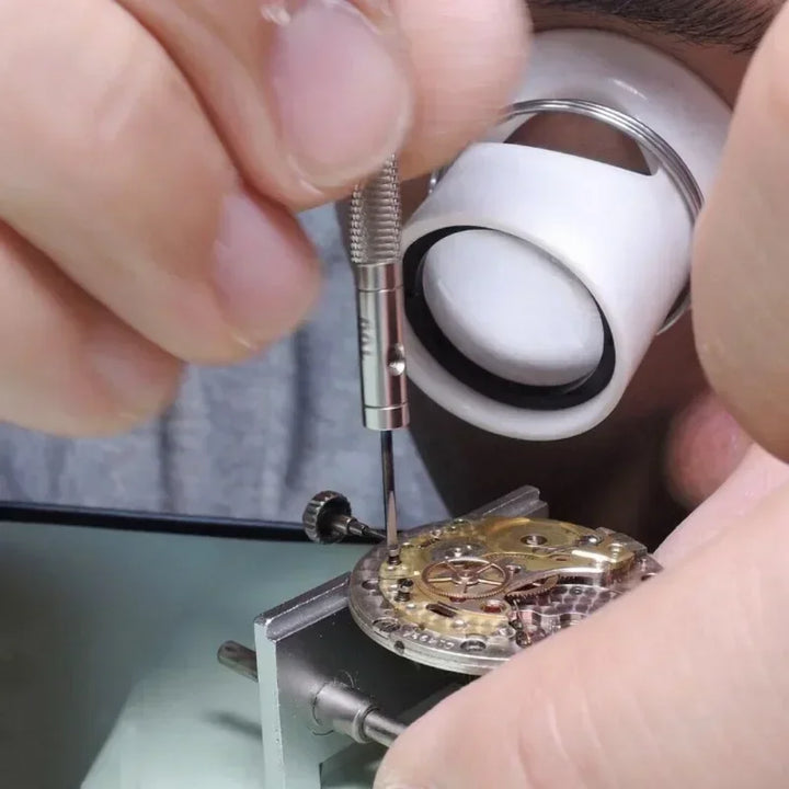 Five precision steel screwdrivers with color-coded heads neatly arranged on a clean wooden surface, alongside a yellow blister pack case showing the full 5-piece set with extra bits.