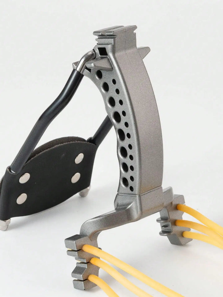 Metallic slingshot with black leather grip on a white background