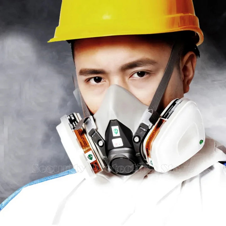17-in-1 6200 Gas Mask Person wearing a yellow hard hat and white protective suit with a respirator mask against a dark background.