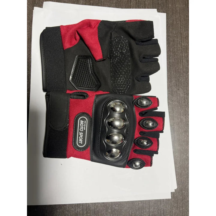 Red and black glove with metallic accents on a white sheet of paper.