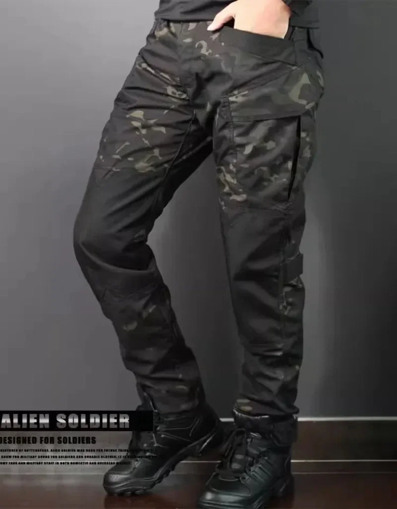 Camouflage tactical pants worn by a person on a dark background