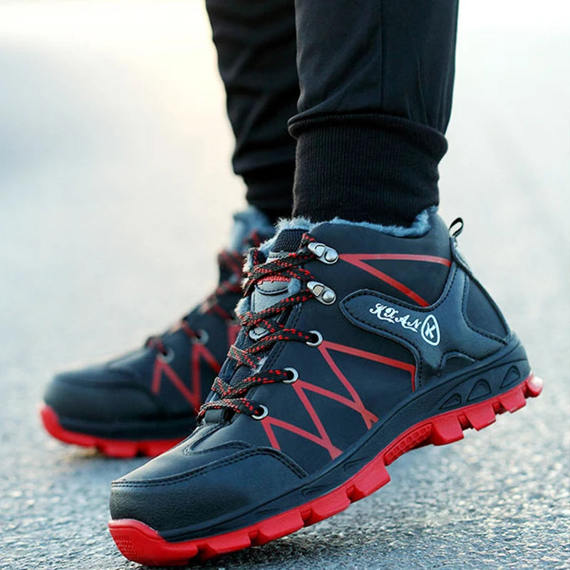Black and red warm-lined safety boots worn by a model on pavement.
