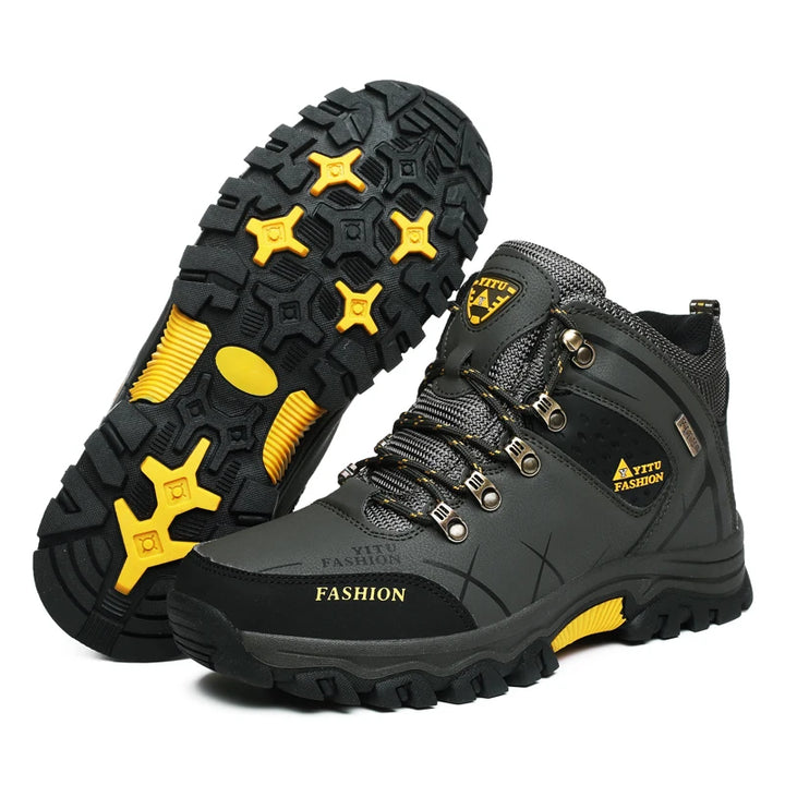  Close-up of green winter boots showcasing the rugged sole with yellow anti-slip features.