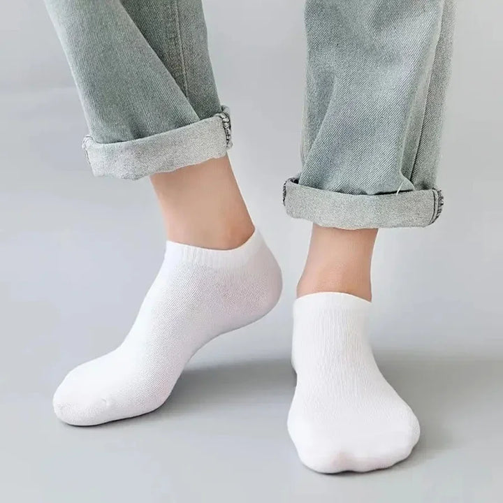 Man wearing white no-show socks, emphasizing lightweight and stretch-fit design.