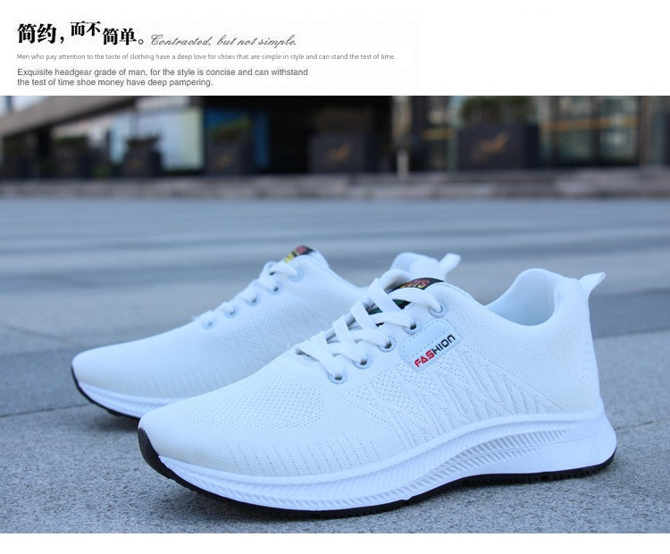 A pair of white sneakers resting on pavement, emphasizing their non-slip sole and fashionable minimalist design.