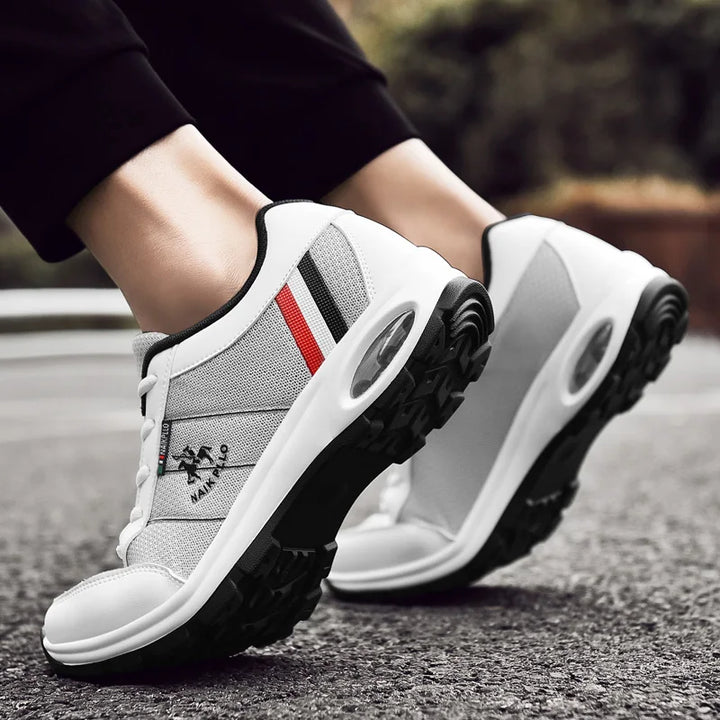 Stylish white and black sneakers paired with jeans for a trendy and casual look.

