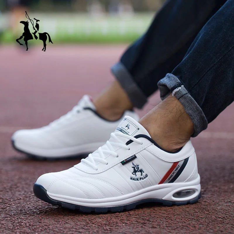  White casual sneakers with black and red detailing, displayed outdoors on pavement.