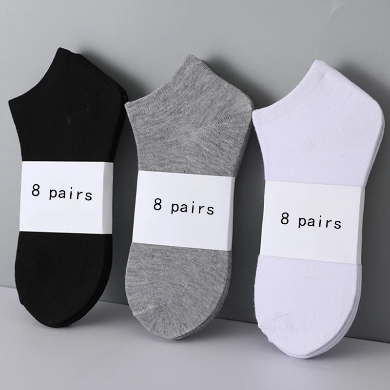 A pack of 8 pairs of black, gray, and white low-cut no-show socks.